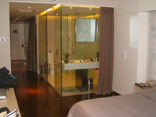a bed with pillows and a mirror wall