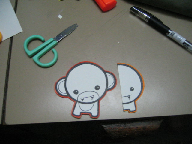 a pair of scissors next to a cut out monkey