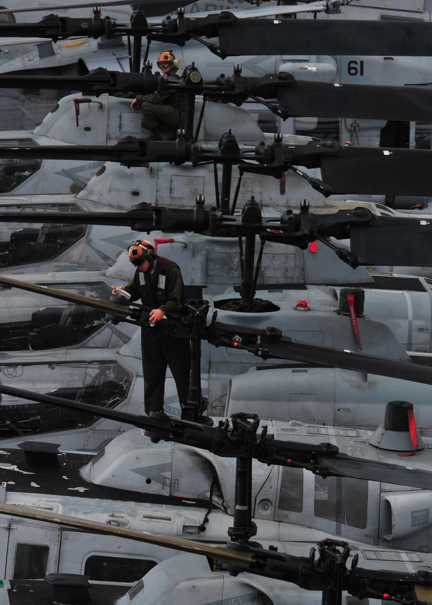 several men in a large military aircraft carrier