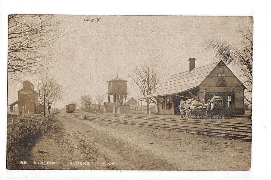 vintage pograph of train tracks and an old train station