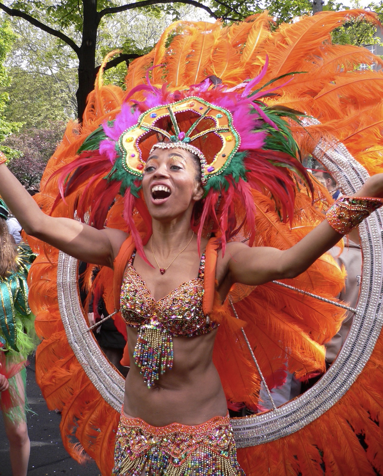 a woman in colorful costume with arms outstretched