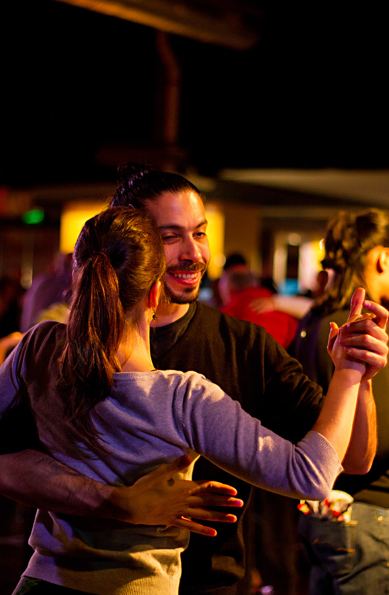 a woman is holding a man while dancing