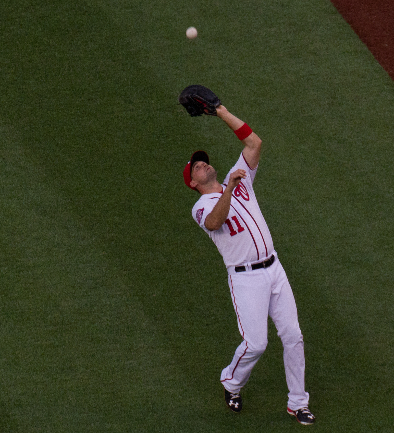 a baseball player catches a ball with his glove