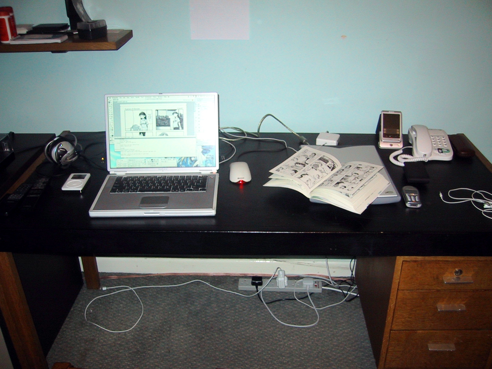 a laptop computer sitting on top of a black desk