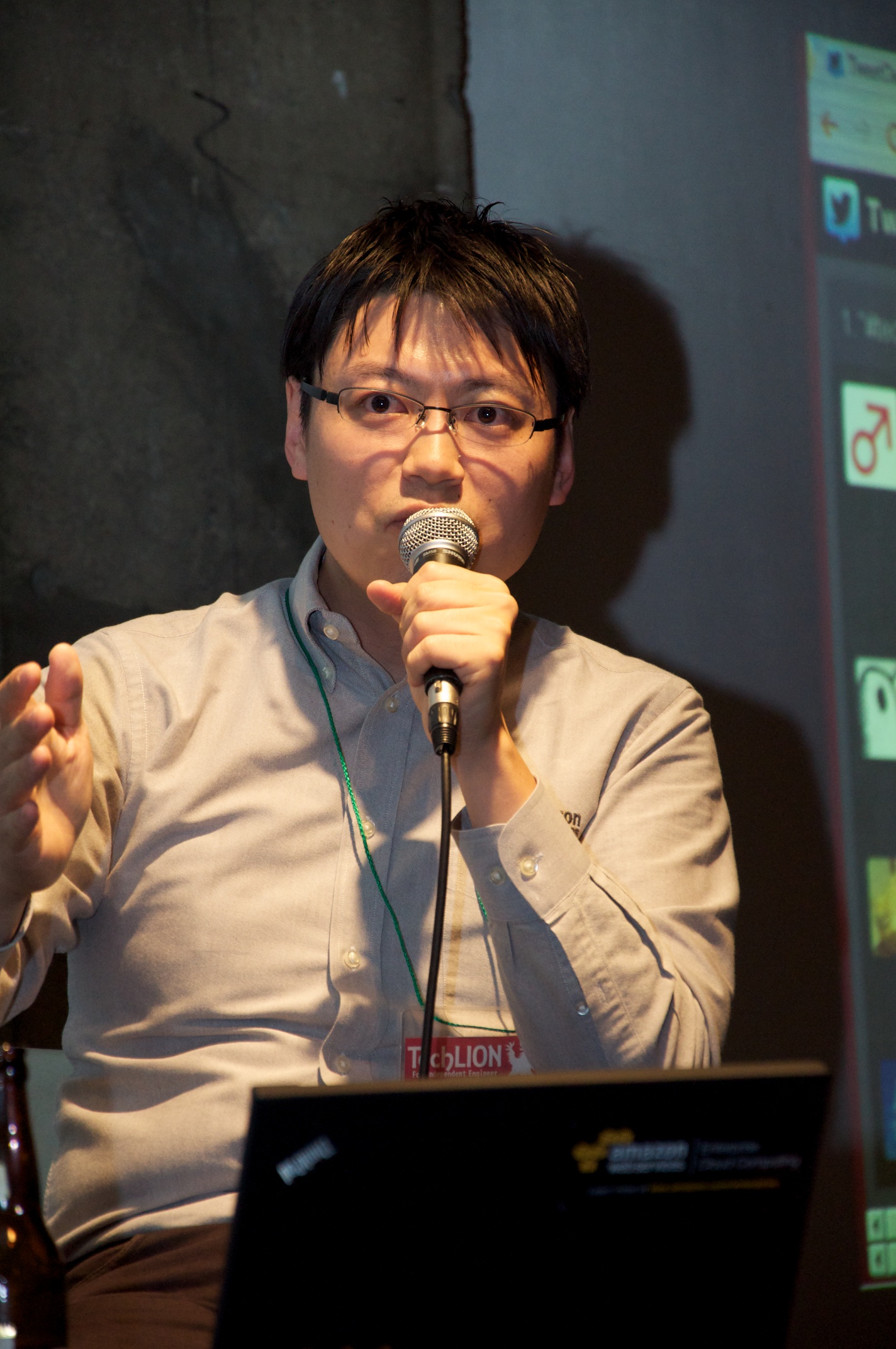 a man with glasses is holding a microphone