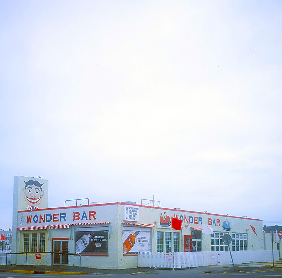 a diner building sitting in an empty lot on a gloomy day