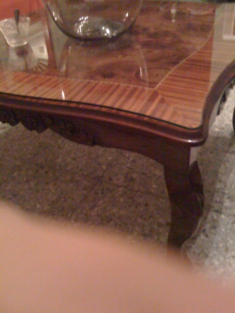 glass and wooden table in living room next to door
