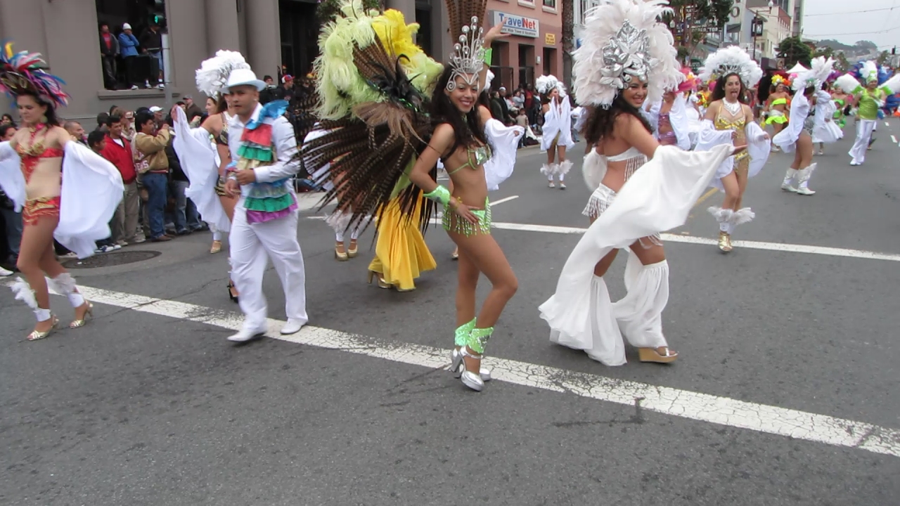 performers in a parade on a street