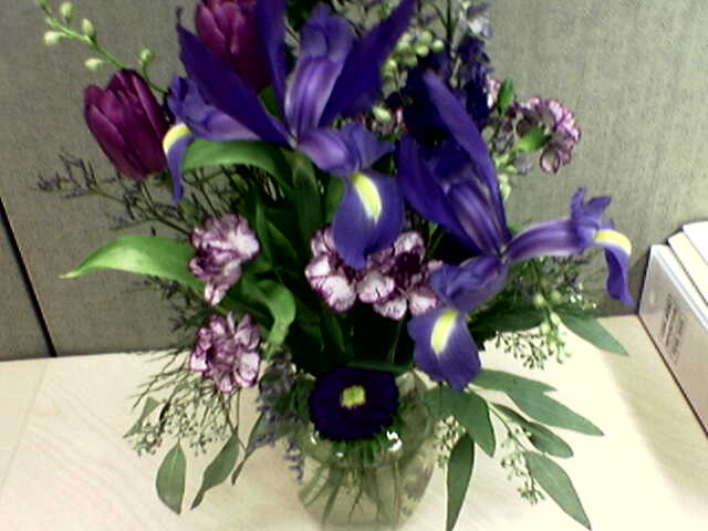 a vase filled with purple and purple flowers