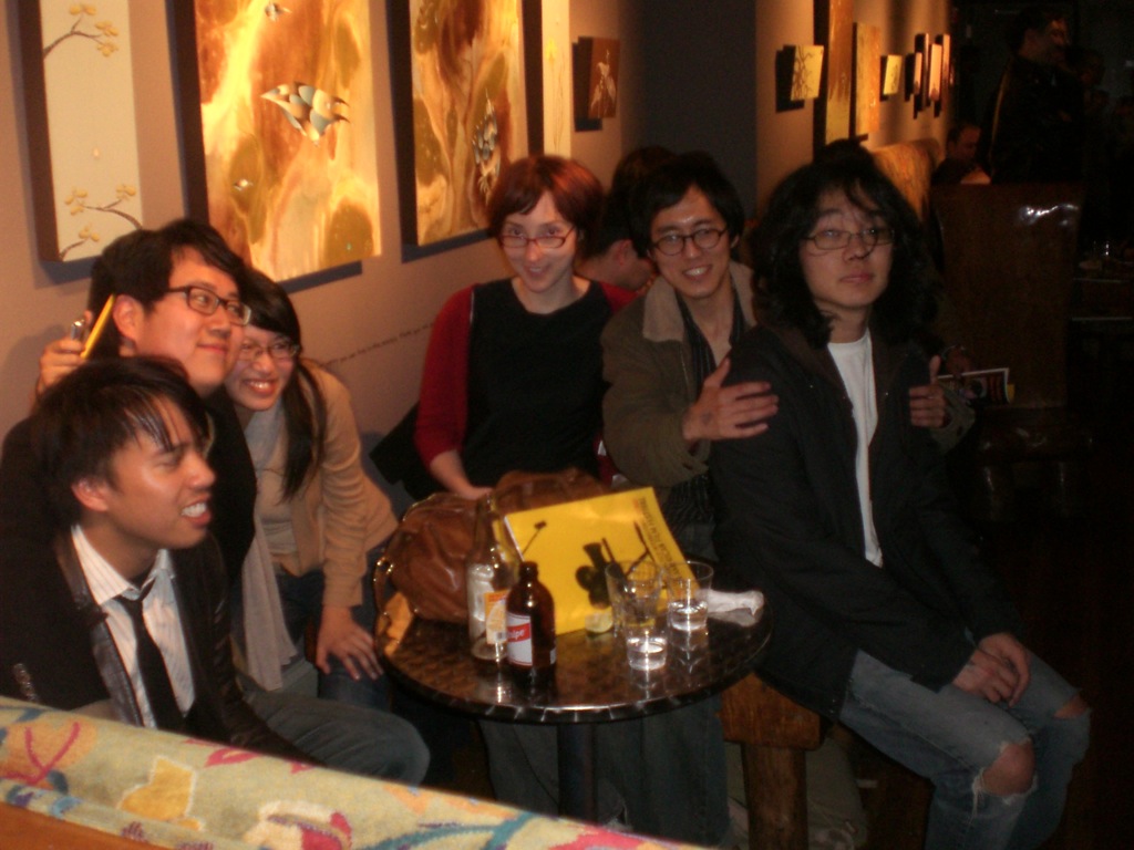 a group of young people are posing together for a po in front of drinks