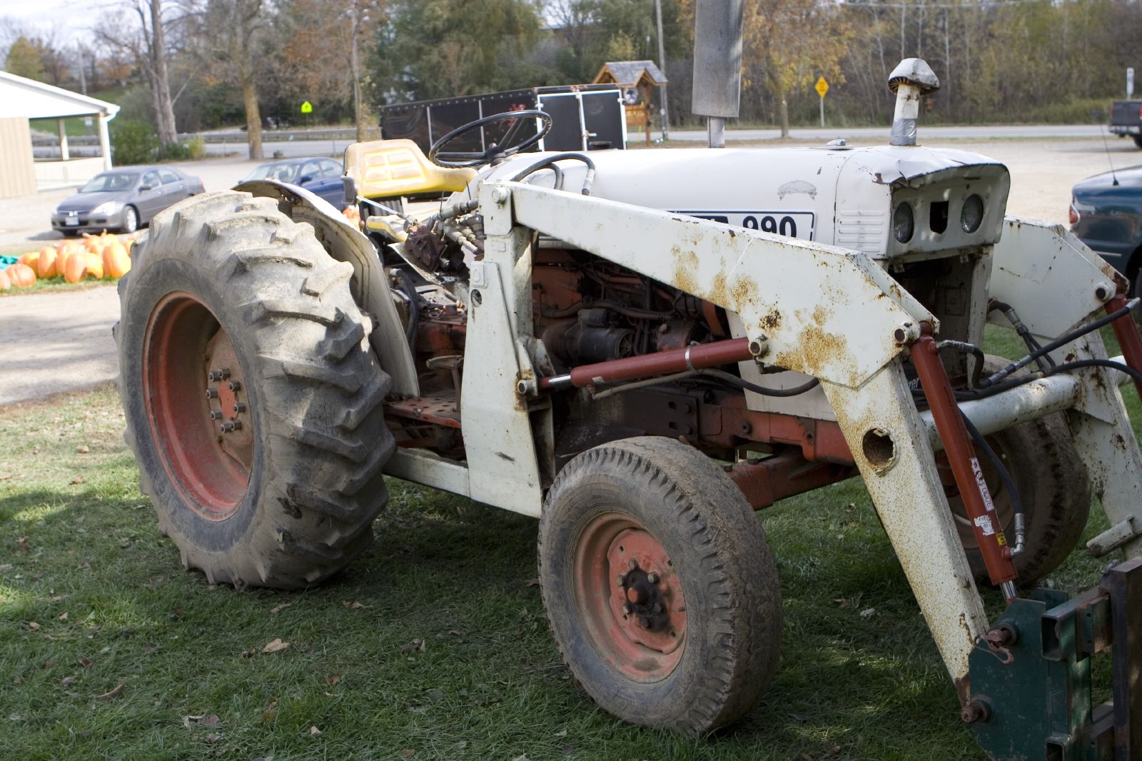 an old tractor is sitting in the grass