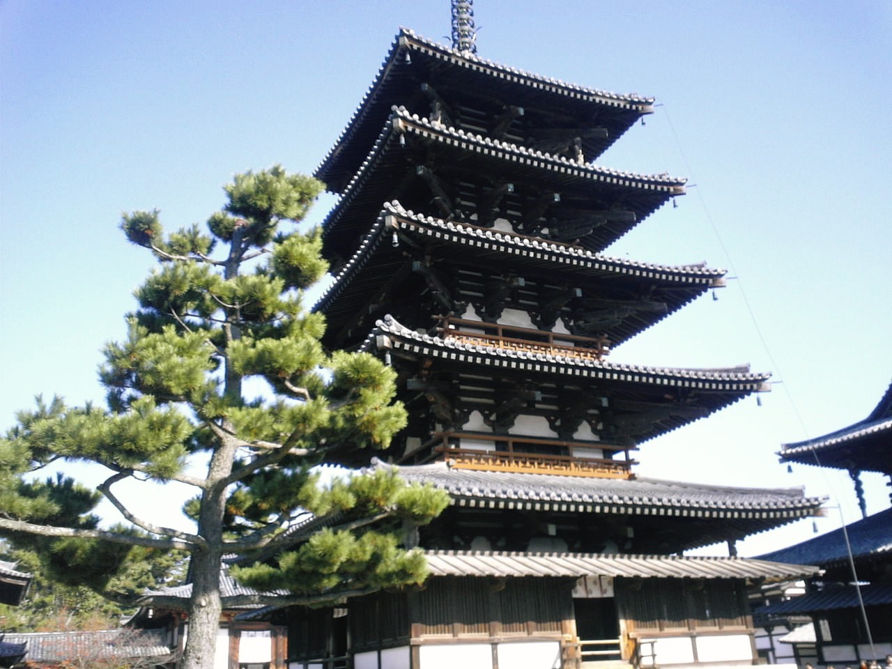 a tall building sitting under a blue sky