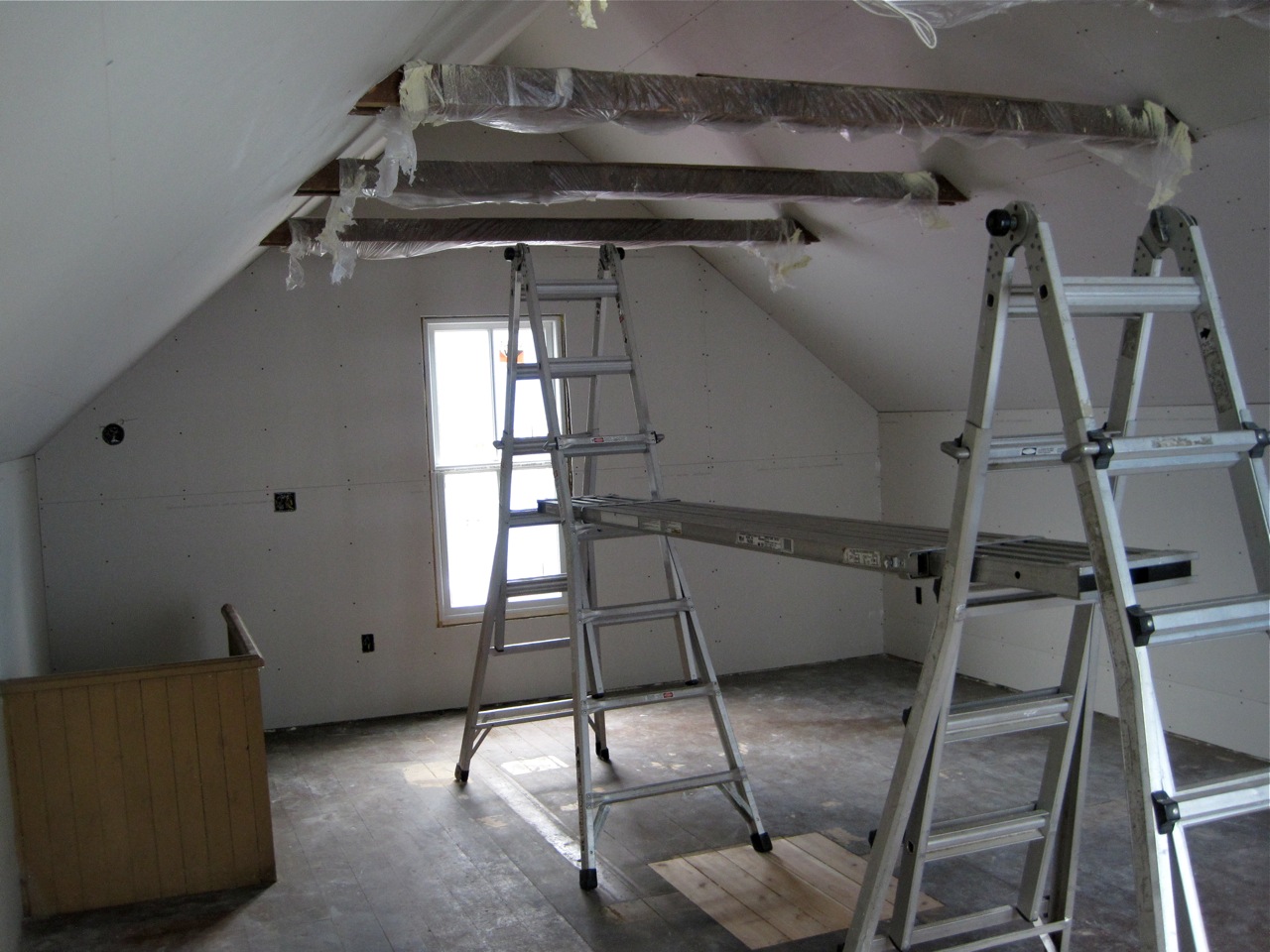 some ladders and windows are being installed inside a room