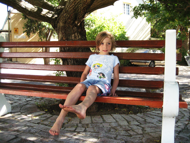  sitting on park bench under tree