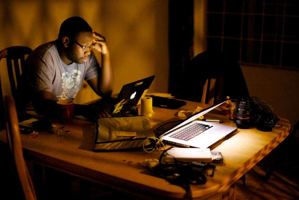 a man sits in front of his laptop computer