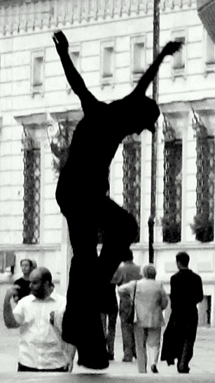 a person in the street practicing a handstand