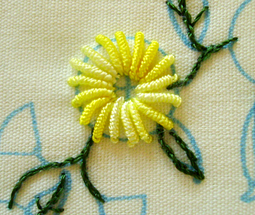 a close up of a machine - embroidered flower