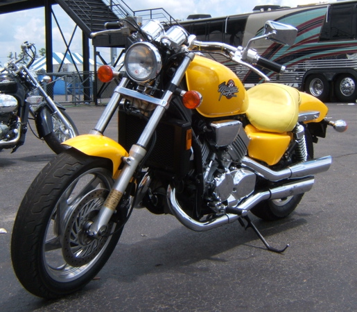 a motorcycle parked in front of some motor vehicles