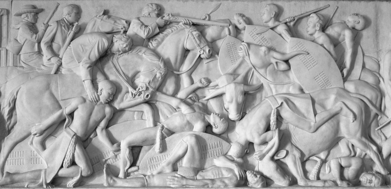 a group of people riding horses near a relief
