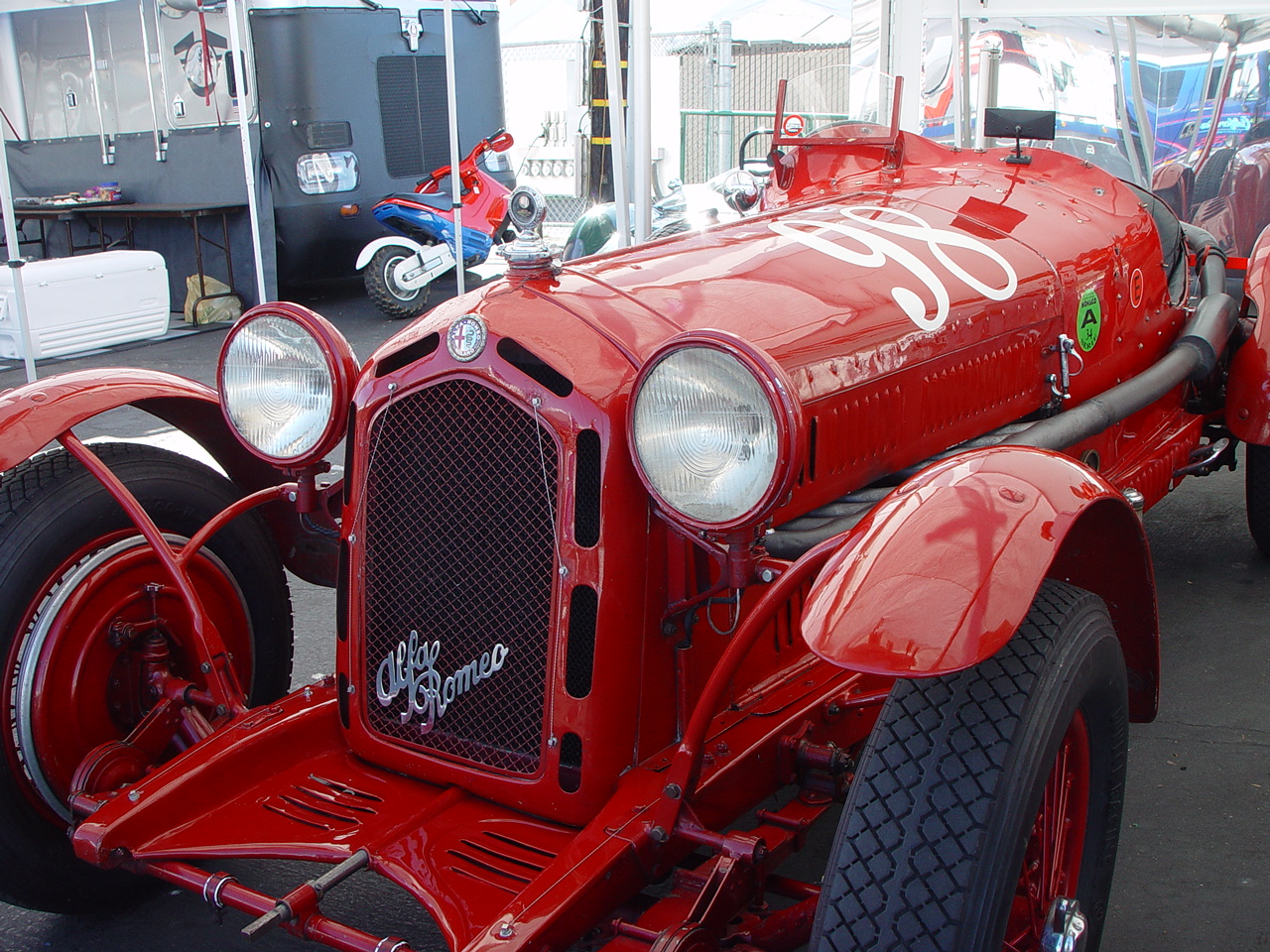 an old red firetruck is on display near other vehicles