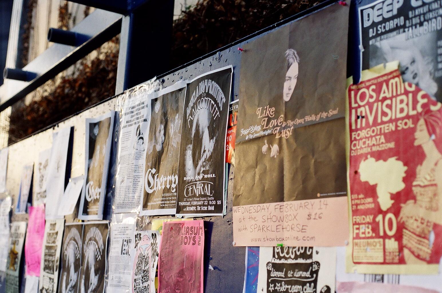 some signs are hanging in a row on a wall