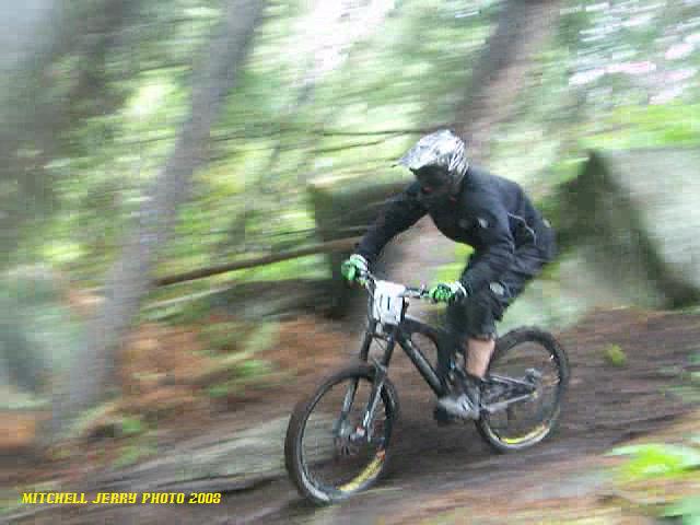 man on a bicycle is riding down a muddy trail