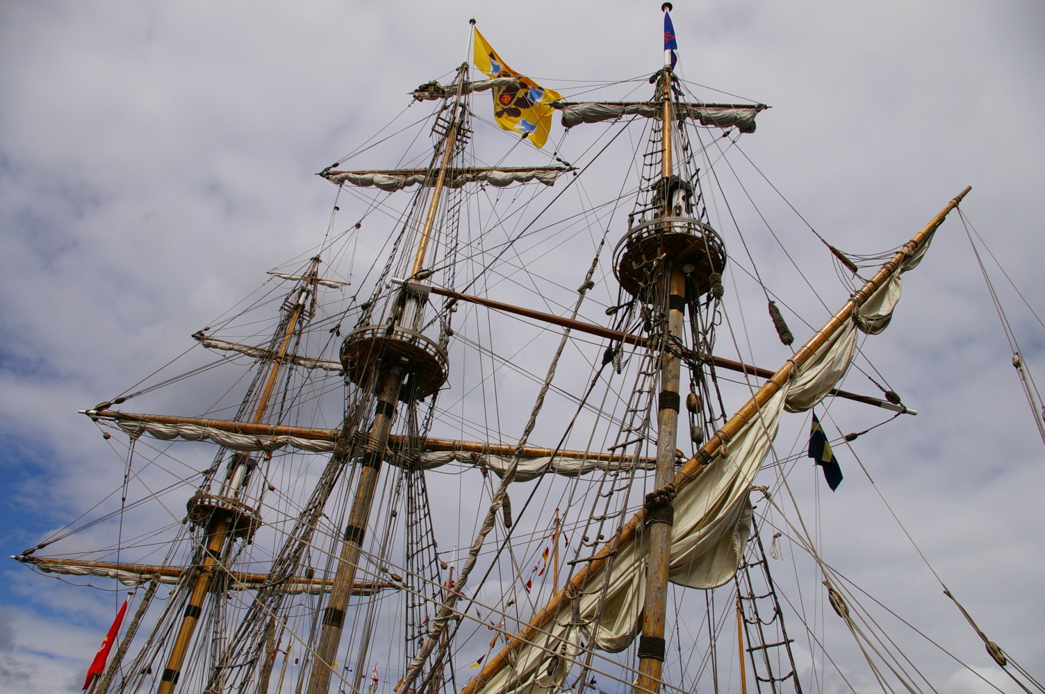 an old ship sailing in the water with masts