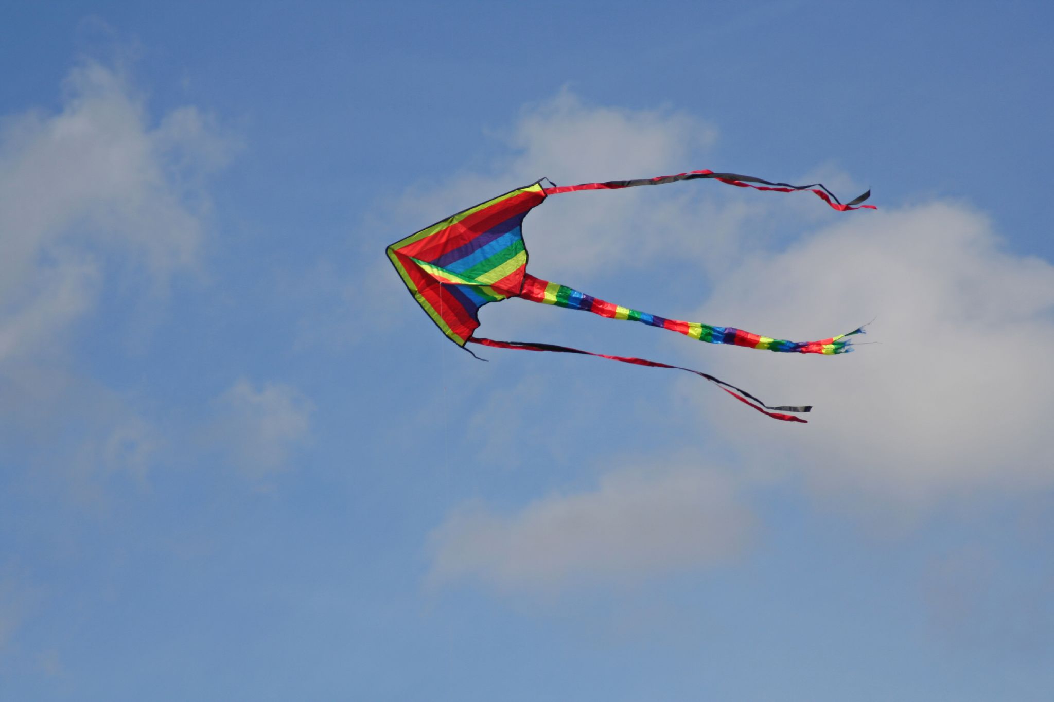 two colorful kites in the blue sky
