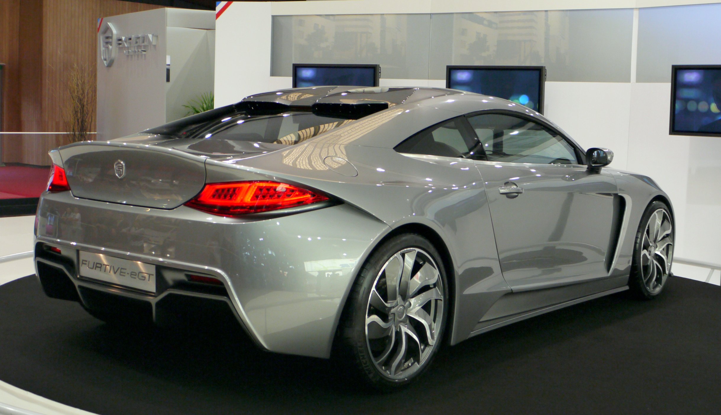 a sports car sits in the showroom