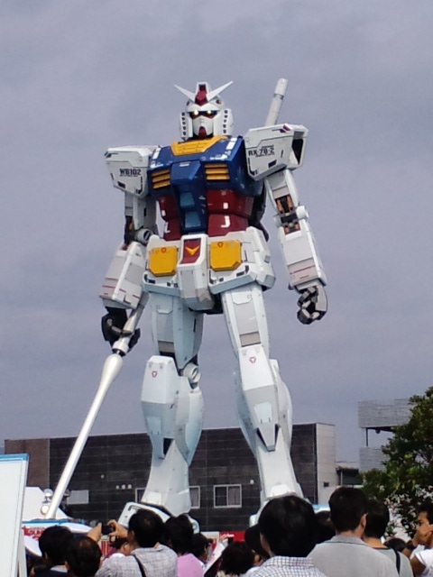 a giant robot standing tall on top of a field