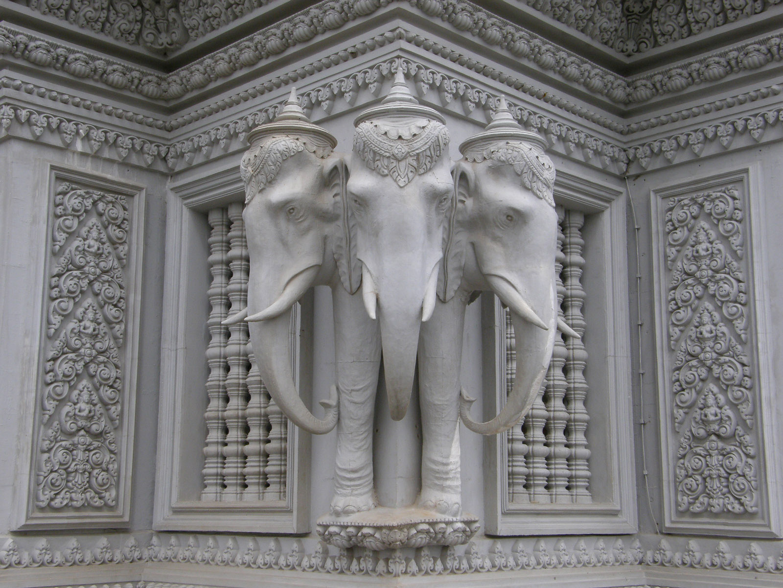 an elephant statue with two elephants on its back