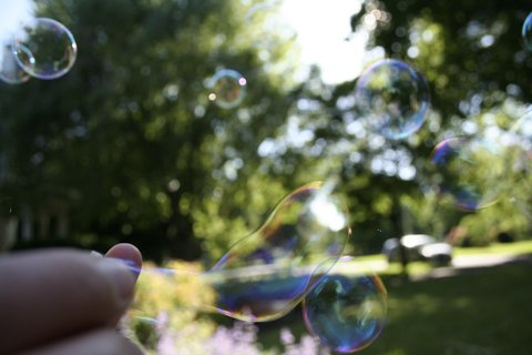 a person holding a soap bubbles that have been released to them