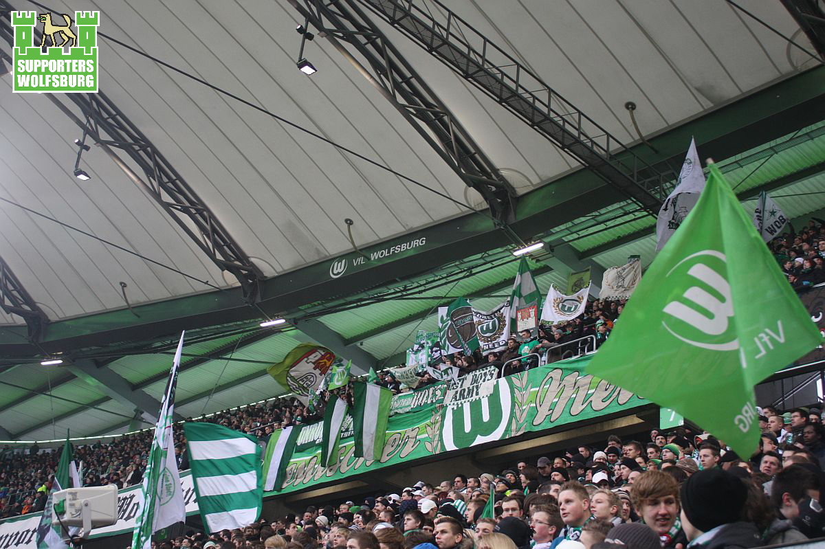 large green flags and people in stands inside a stadium