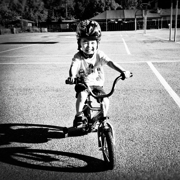 a small child is wearing a helmet riding a bike