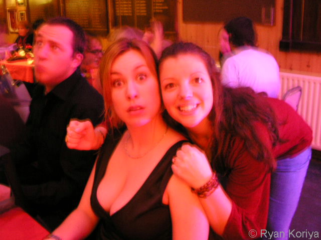 three people in a bar posing for the camera