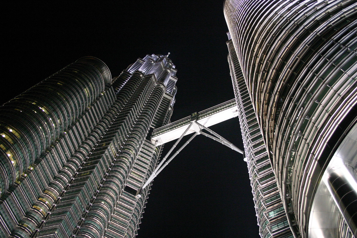 two very tall buildings in the middle of the night