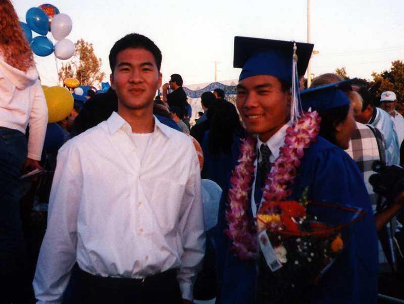 there are two men standing together and smiling at the same time