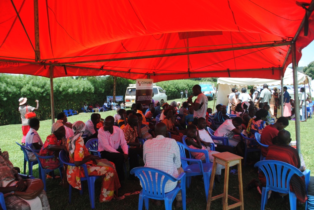 there is an event with people under a large red canopy