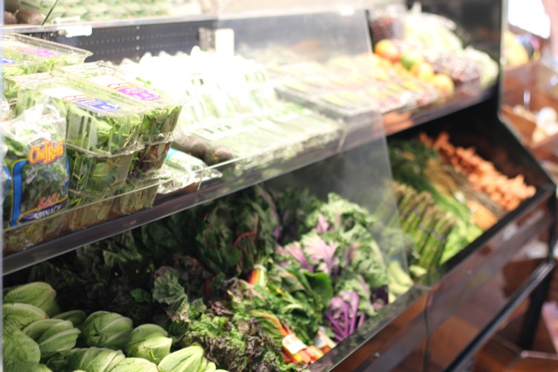 vegetables are on display in the produce section of a grocery store