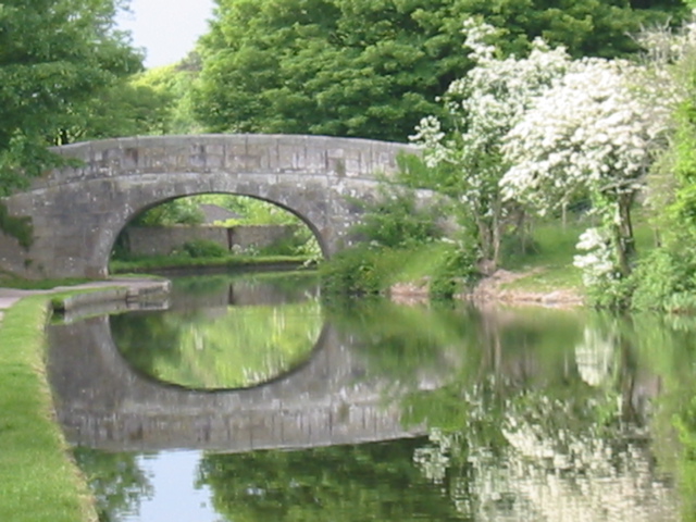 there is a bridge that is reflecting in the water