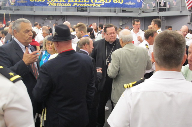 two military men speaking to a group of people