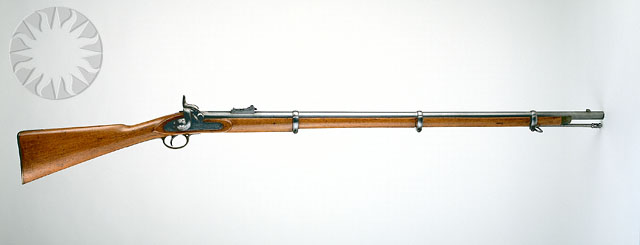 a machine gun is mounted to a wall