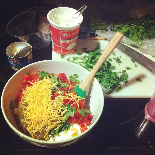 a bowl full of vegetables and cheese on top of a table