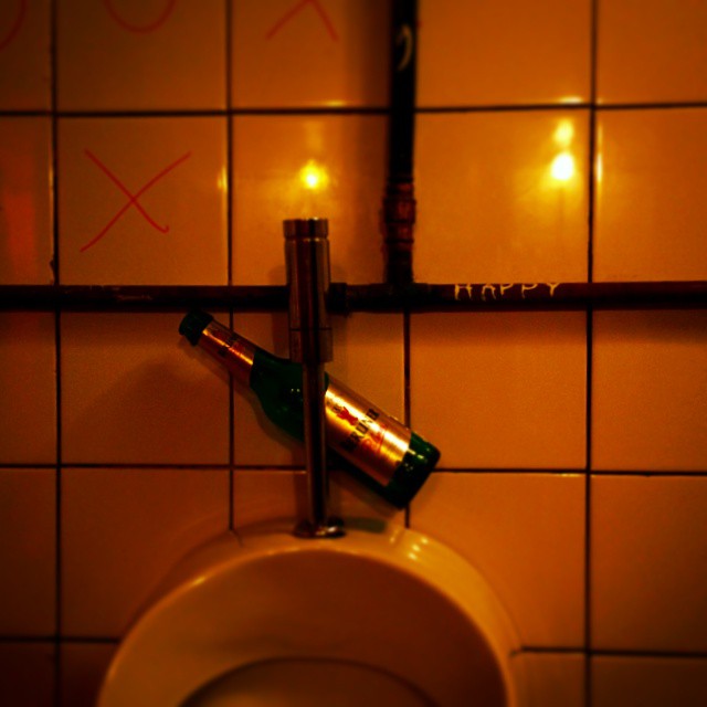 toilet urinal with a cigarette lighter attached to it