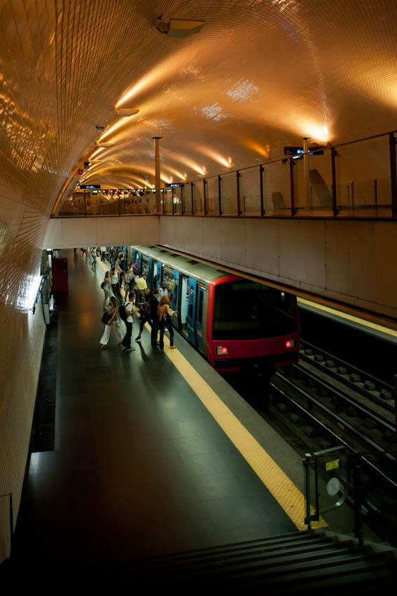 the train station has many people walking on the platform