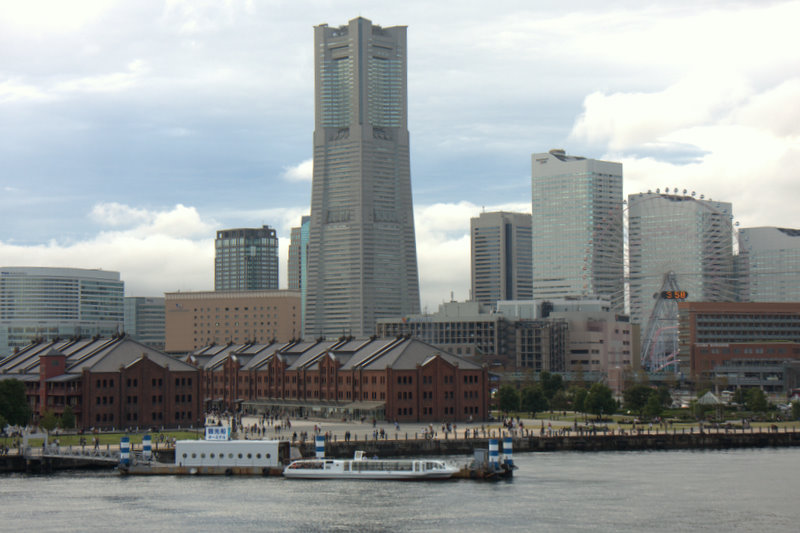 a couple of buildings sitting in front of a body of water