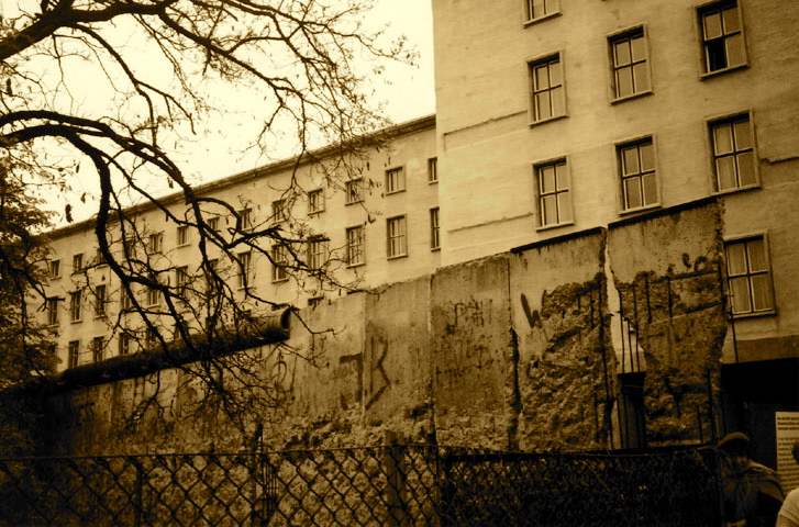 a building and a tree outside in sepia
