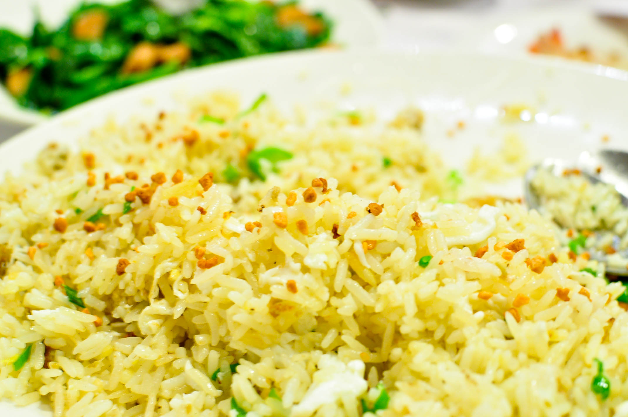 a white plate filled with rice and vegetables