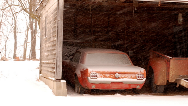 red car parked outside in the snow with its doors open