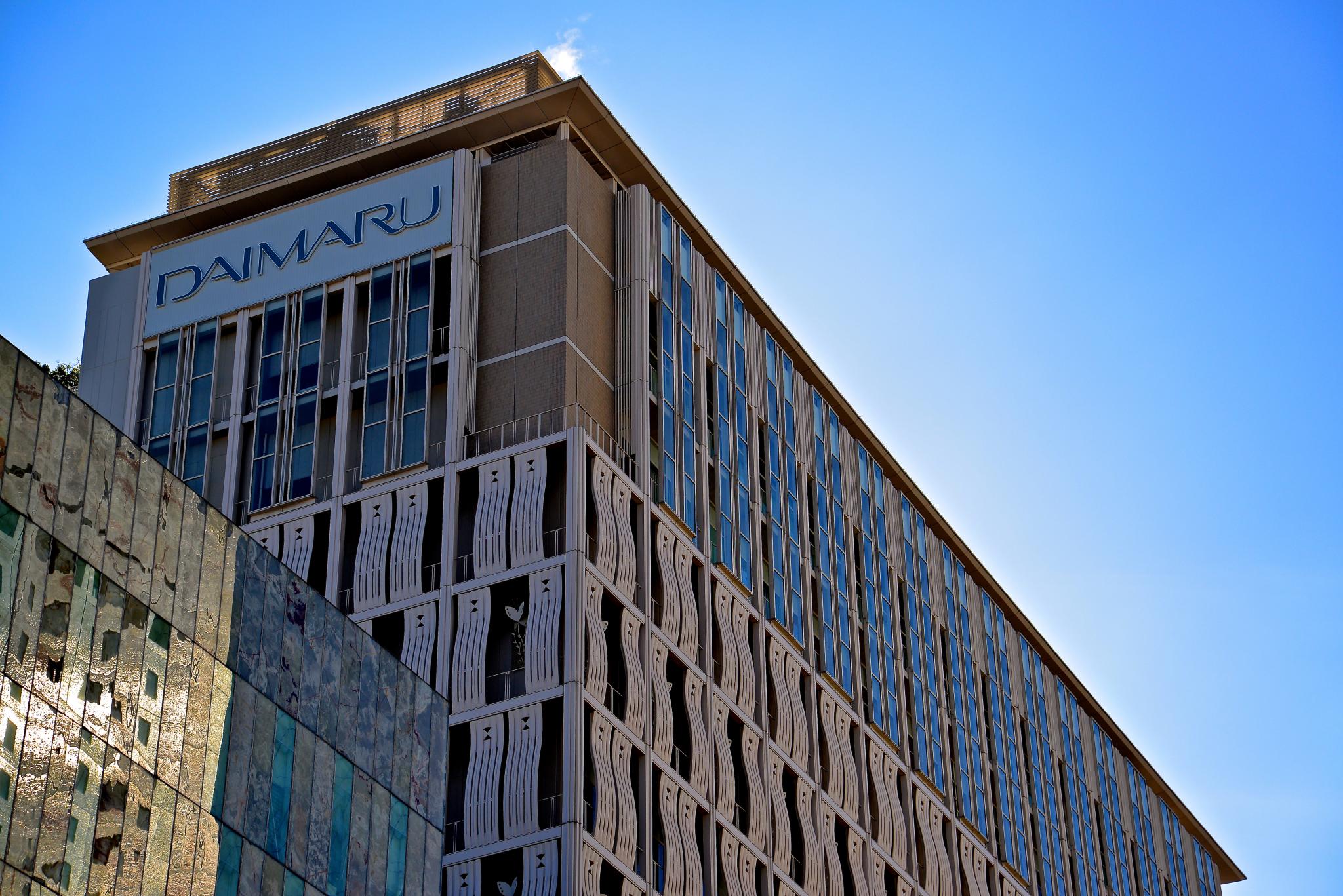 a very tall building sitting in front of a clear blue sky